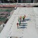 Construction workers utilizing real-time site logs on a job site.
