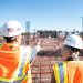 Construction workers discussing project plans at a job site