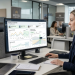 Revenue manager viewing real-time hotel performance and pricing dashboards on multiple screens