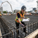 Construction team conducting a quality inspection on a job site using a digital tablet.