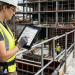 Construction professionals inspecting blueprints against Dubai city skyline