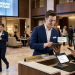 Hotel operations manager reviewing standardized service performance dashboards across multiple properties