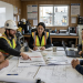 Construction managers using digital inspection software on-site.